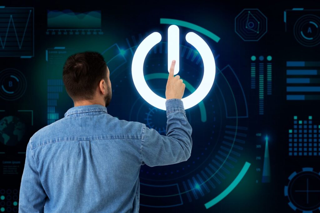 Homem de costas tocando um ícone de “power” gigante em uma tela digital com gráficos futuristas, simbolizando o início ou ativação de um negócio online com base em tecnologia, inovação e automação. Representa o conceito de dar o primeiro passo rumo ao empreendedorismo digital.